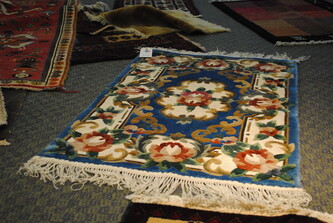 Persian rug collection with floral print for sale in rug shop.
