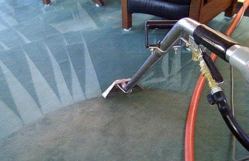 Professional cleaning being done on residential carpet with commercial carpet cleaning equipment.