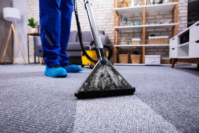 Professional Cleaning Service cleaning the low-pile carpet of an office room.